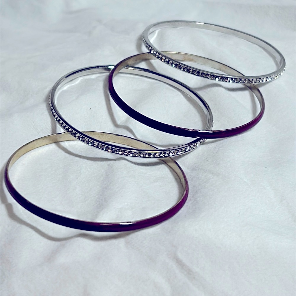 Set of 4 dangle bracelets. 2 rhinestones all around.  2 purple enamel NWOT